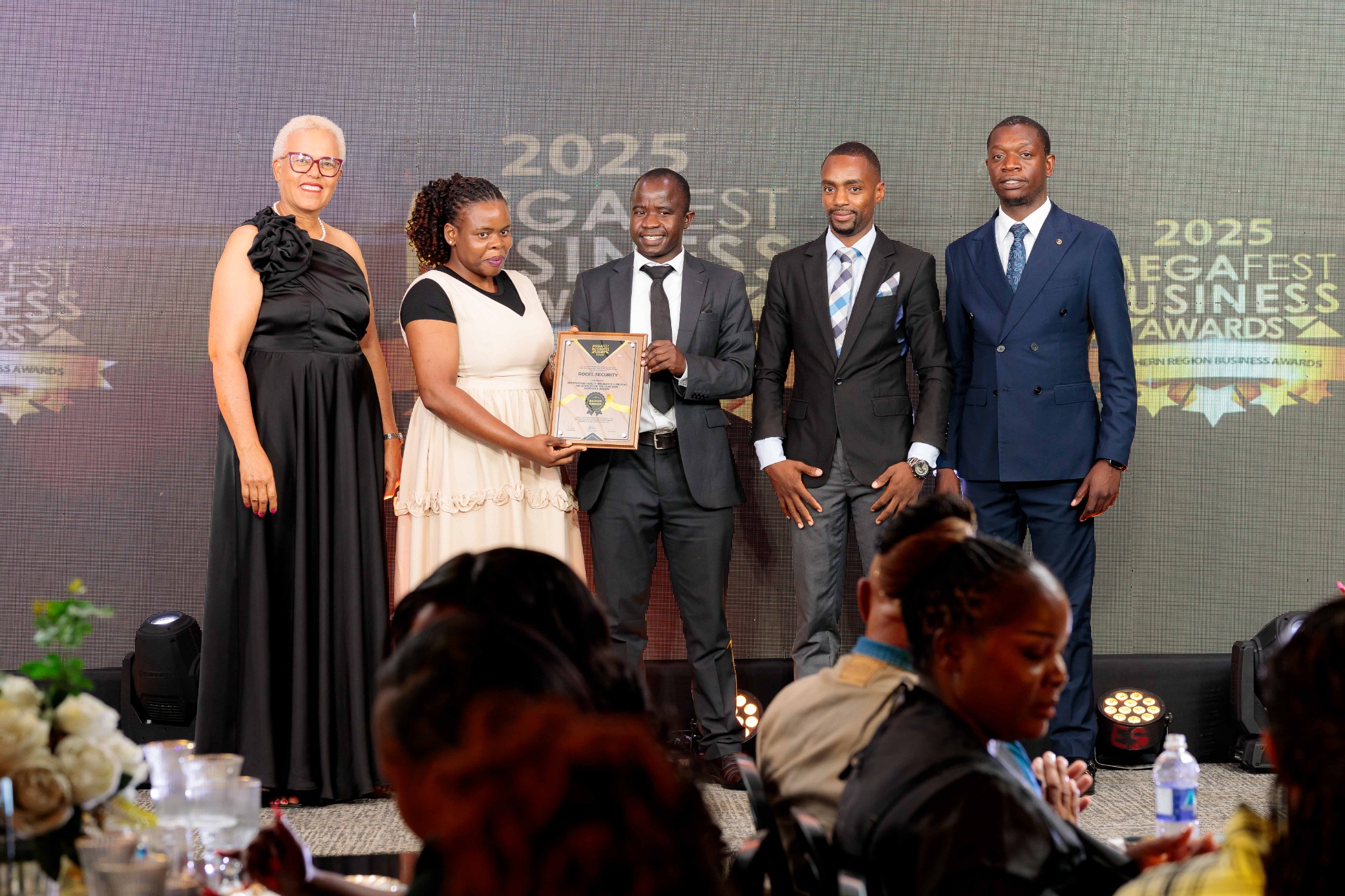 Rogel Security team receiving a Megafest business award