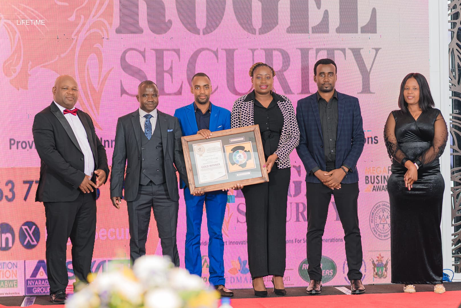 Rogel Security representatives with a framed award